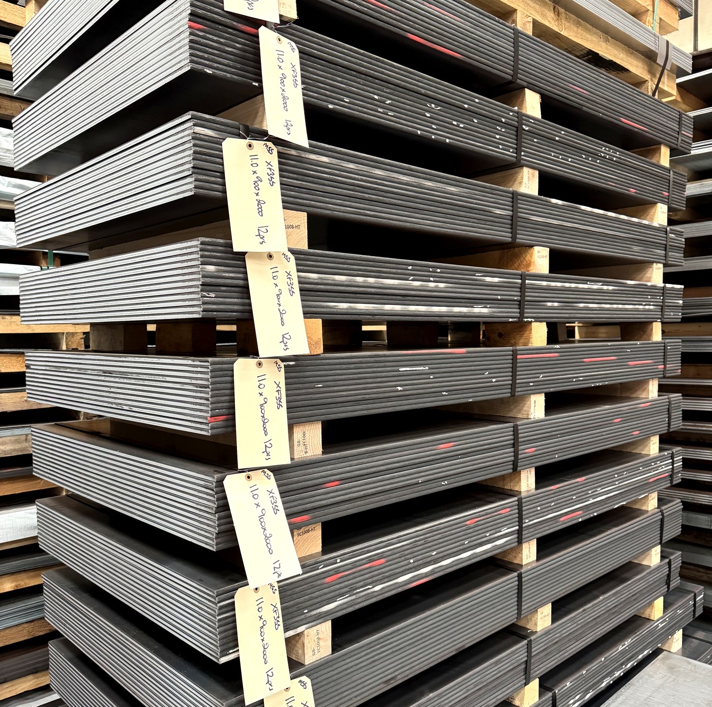 Stacked sheet steel in stock at Midland Steel Supplies, West Midlands